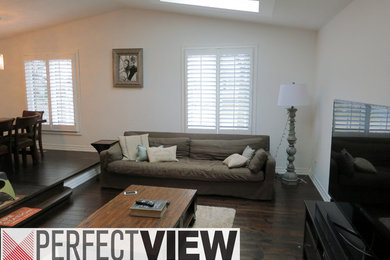 Inspiration for a mid-sized transitional open concept dark wood floor living room remodel in Toronto with white walls, no fireplace and a tv stand