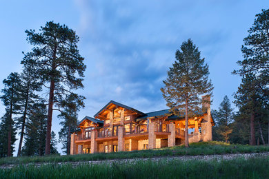 Example of a large mountain style two-story wood exterior home design in Denver