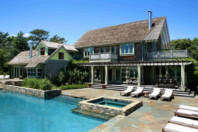 Inspiration for a large timeless backyard stone and rectangular lap hot tub remodel in New York