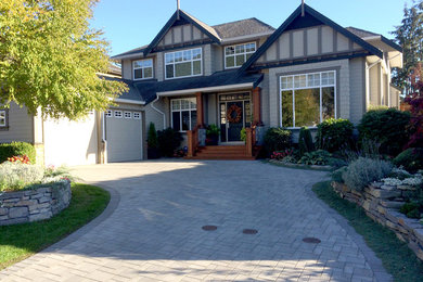 Example of a large arts and crafts gray two-story wood gable roof design in Vancouver