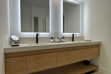 Large danish ceramic tile and beige floor bathroom photo in New York with flat-panel cabinets, medium tone wood cabinets, a one-piece toilet, white walls, an undermount sink, quartzite countertops, a hinged shower door, beige countertops and a floating vanity