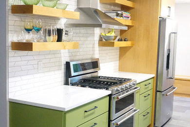 Example of a mid-sized mid-century modern galley vinyl floor and gray floor kitchen design in Portland with a farmhouse sink, flat-panel cabinets, medium tone wood cabinets, quartz countertops, white backsplash, porcelain backsplash, stainless steel appliances and white countertops