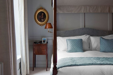 Inspiration for a traditional bedroom in London with grey walls, carpet and beige floor.