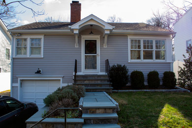 Example of a gray clapboard house exterior design in New York