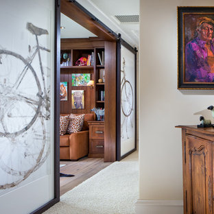 Design ideas for a large traditional study room in Orange County with brown walls and light hardwood floors.