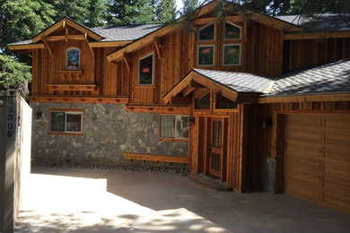 Example of a large mountain style brown two-story mixed siding exterior home design in Other with a shingle roof