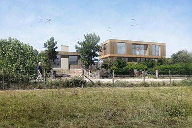 Contemporary two floor detached house in Sussex with wood cladding and a flat roof.