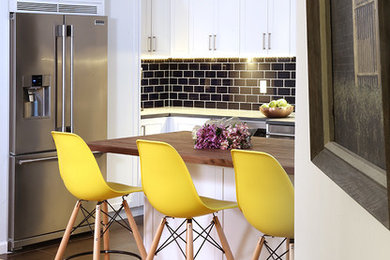 Mid-sized country u-shaped porcelain tile and brown floor eat-in kitchen photo in New York with a farmhouse sink, shaker cabinets, white cabinets, soapstone countertops, blue backsplash, ceramic backsplash, stainless steel appliances and an island