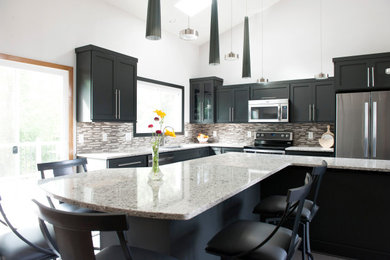 Example of a large minimalist l-shaped ceramic tile and gray floor eat-in kitchen design in Other with an undermount sink, shaker cabinets, black cabinets, granite countertops, multicolored backsplash, mosaic tile backsplash, stainless steel appliances, an island and white countertops