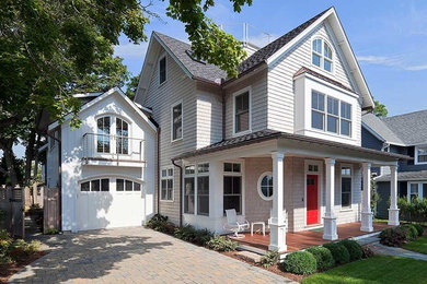 This is an example of a mid-sized traditional two-storey grey house exterior in New York with a gable roof, a shingle roof, mixed siding, a grey roof and shingle siding.