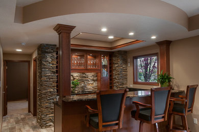 This is an example of a large transitional home bar in Minneapolis with porcelain floors.