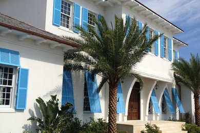 Design ideas for a large tropical two-storey stucco white exterior in Tampa.