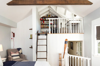 Example of a small beach style loft-style medium tone wood floor bedroom design in Los Angeles with gray walls and no fireplace