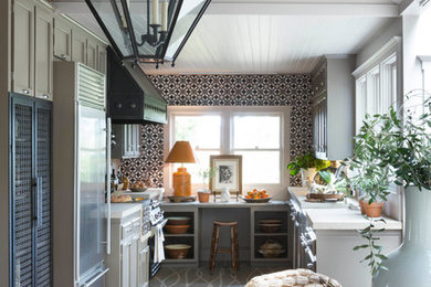 Cottage painted wood floor eat-in kitchen photo in San Francisco with a farmhouse sink, shaker cabinets, gray cabinets, multicolored backsplash, stainless steel appliances and no island