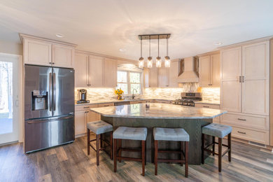 Inspiration for a large contemporary l-shaped vinyl floor and gray floor eat-in kitchen remodel in Other with an undermount sink, shaker cabinets, dark wood cabinets, granite countertops, gray backsplash, glass tile backsplash, stainless steel appliances, an island and gray countertops
