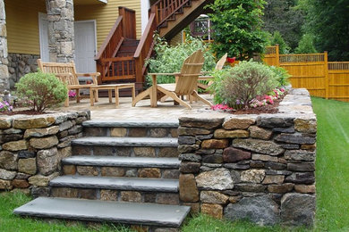 Mid-sized mountain style backyard brick patio container garden photo in Boston with no cover