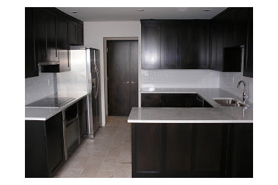 This is an example of a contemporary u-shaped eat-in kitchen in Columbus with recessed-panel cabinets and dark wood cabinets.