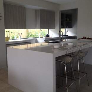 Large modern kitchen pantry pictures - Inspiration for a large modern galley porcelain floor kitchen pantry remodel in Geelong with an undermount sink, flat-panel cabinets, light wood cabinets, quartz countertops and an island