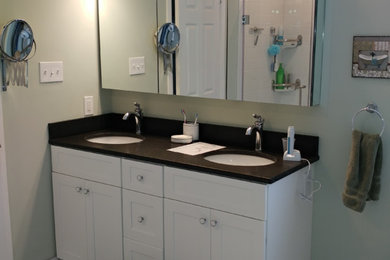 Example of a large trendy master marble floor alcove shower design in Philadelphia with shaker cabinets, white cabinets, green walls, an undermount sink and solid surface countertops