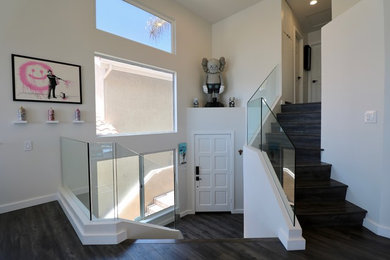Staircase - mid-sized modern wooden straight glass railing staircase idea in Orange County with wooden risers