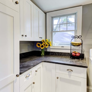 Mid-sized craftsman kitchen pantry photos - Inspiration for a mid-sized craftsman l-shaped porcelain floor kitchen pantry remodel in Providence with shaker cabinets, white cabinets, granite countertops, gray backsplash and no island