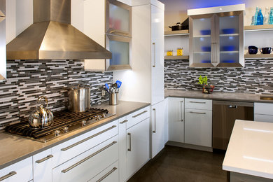 Inspiration for a modern l-shaped concrete floor and gray floor kitchen remodel with flat-panel cabinets, white cabinets, quartz countertops, gray backsplash, matchstick tile backsplash, stainless steel appliances and an island