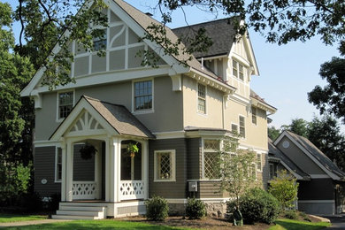 Example of a large classic beige two-story stucco exterior home design in Boston with a shingle roof