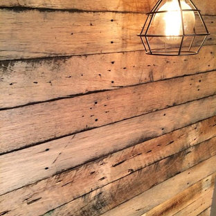 Inspiration for a mid-sized industrial home theater remodel in Canberra - Queanbeyan with gray walls and a media wall