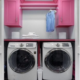 Inspiration for a small classic single-wall laundry cupboard in Philadelphia with recessed-panel cabinets, composite countertops, laminate floors, black floors and grey walls.