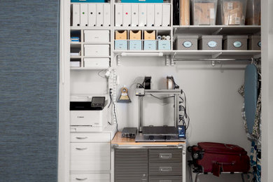 Inspiration for a mid-sized contemporary gender-neutral concrete floor and gray floor reach-in closet remodel in Austin with flat-panel cabinets and light wood cabinets