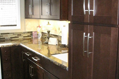 Inspiration for a huge eclectic l-shaped porcelain tile dedicated laundry room remodel in Other with an undermount sink, shaker cabinets, dark wood cabinets, granite countertops, beige walls and a stacked washer/dryer