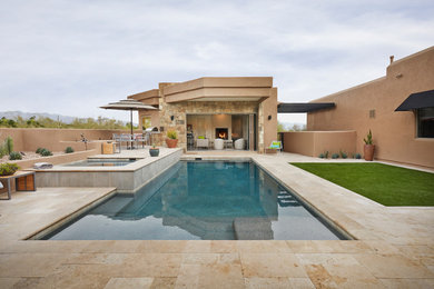 Inspiration for a backyard rectangular lap pool in Phoenix with a pool house and tile.