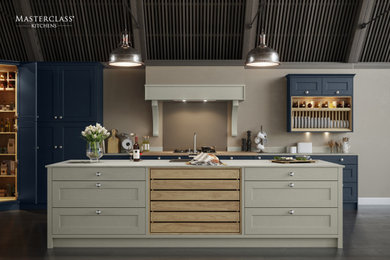Inspiration for a large traditional l-shaped kitchen/diner in West Midlands with a single-bowl sink, recessed-panel cabinets, blue cabinets, laminate countertops, brown splashback, glass sheet splashback, black appliances, dark hardwood flooring, an island, black floors, white worktops and feature lighting.