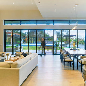 A modern great room built for crowds with NanaWall opening glass doors.