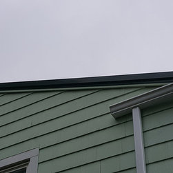 Metal Roof on Split-level Home - Roofing And Gutters