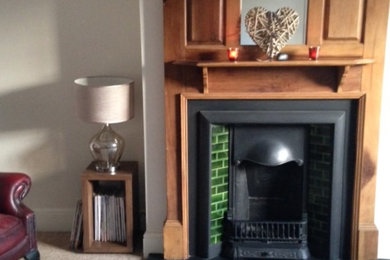 Inspiration for a medium sized traditional open plan living room in Devon with a reading nook, beige walls, carpet, a standard fireplace, a wooden fireplace surround and a freestanding tv.