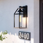 Vaxcel - Napier 6.25" Outdoor Wall Light Forged Black and Rustic Elm - The Napier collection features forged black iron paired with a warm rustic Elm wood finish creating a two-tone design ideal for industrial or modern decor. An open and airy frame encases an elongated clear seeded glass shade offering the maximum light output for your outdoor spaces. For added security, this wall mount light fixture has a built-in photocell sensor that automatically turns the light on at dusk and off at dawn, saving you energy during daylight hours. Made of weather resistant materials that can withstand rain, sleet and snow providing long lasting durability for the safety of your family and home. This lantern sconce is perfect for a wide variety of applications including your front door, porch, patio, garage, barn, entryway, and more!