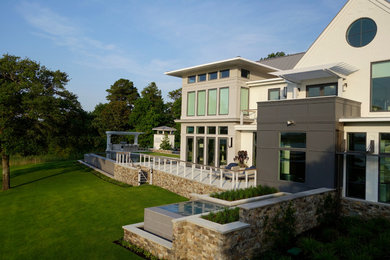 Inspiration for a large contemporary two-storey beige exterior in Wilmington with mixed siding and a gable roof.