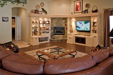 Living room - large traditional open concept dark wood floor living room idea in Phoenix with a corner fireplace, a media wall, green walls and a stone fireplace