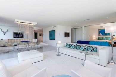 Large contemporary open concept living room in Miami with white walls, porcelain floors, no fireplace, a wall-mounted tv and white floor.