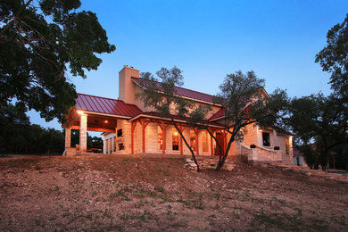 Inspiration for a large modern beige two-story stone exterior home remodel in Austin
