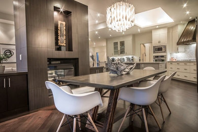 Great room - mid-sized contemporary dark wood floor and brown floor great room idea in Calgary with white walls, a two-sided fireplace and a wood fireplace surround