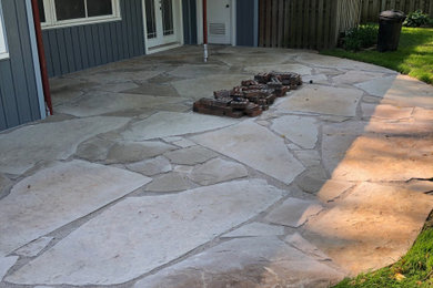 Design ideas for a contemporary backyard garden in Other with with rock feature and natural stone pavers.