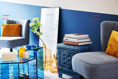 Inspiration for a large contemporary formal and enclosed medium tone wood floor and white floor living room remodel in Amsterdam with blue walls, a wood stove and a concealed tv