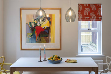 Photo of a small retro open plan dining room in London.