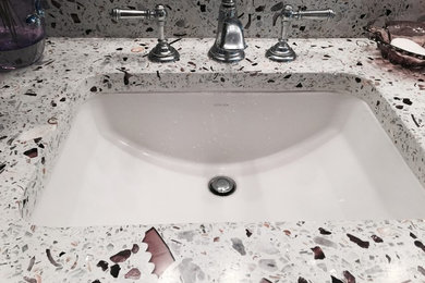 Mid-sized 3/4 black tile, gray tile, pink tile, white tile and mosaic tile dark wood floor bathroom photo in Philadelphia with raised-panel cabinets, black cabinets, a one-piece toilet, gray walls, a drop-in sink and granite countertops