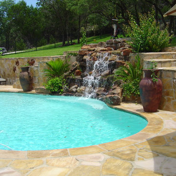 Pool with Moss Rock Waterfall and Flagstone Deck