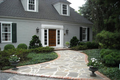Design ideas for a mid-sized farmhouse shade front yard stone landscaping in New York for spring.