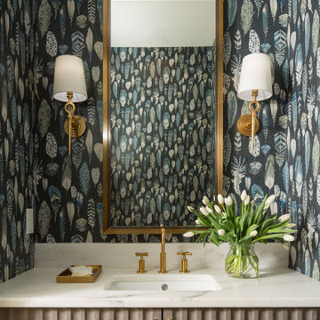Statement Powder Room with Patterned Wallpaper, Fluted Vanity & Brass Fixtures