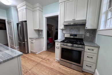Inspiration for a coastal kitchen remodel in Other with shaker cabinets and granite countertops